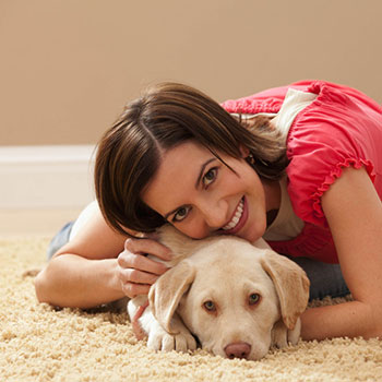 Woman and Dog laying on clean carpet