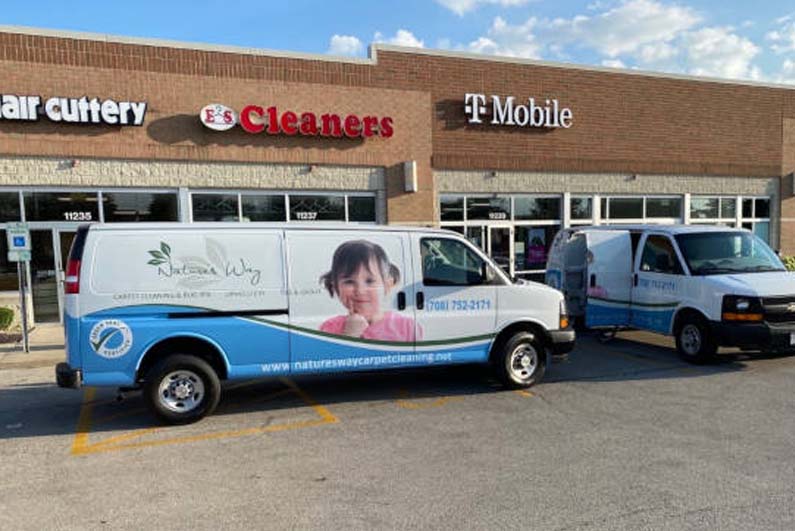 Two Carpet Cleaning Vans outside commercial properties
